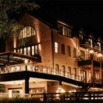 Elegant riverside dining room with jewel-toned velvet armchairs at Odette's