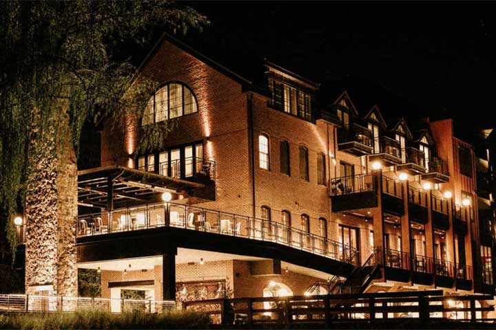 Elegant riverside dining room with jewel-toned velvet armchairs at Odette's